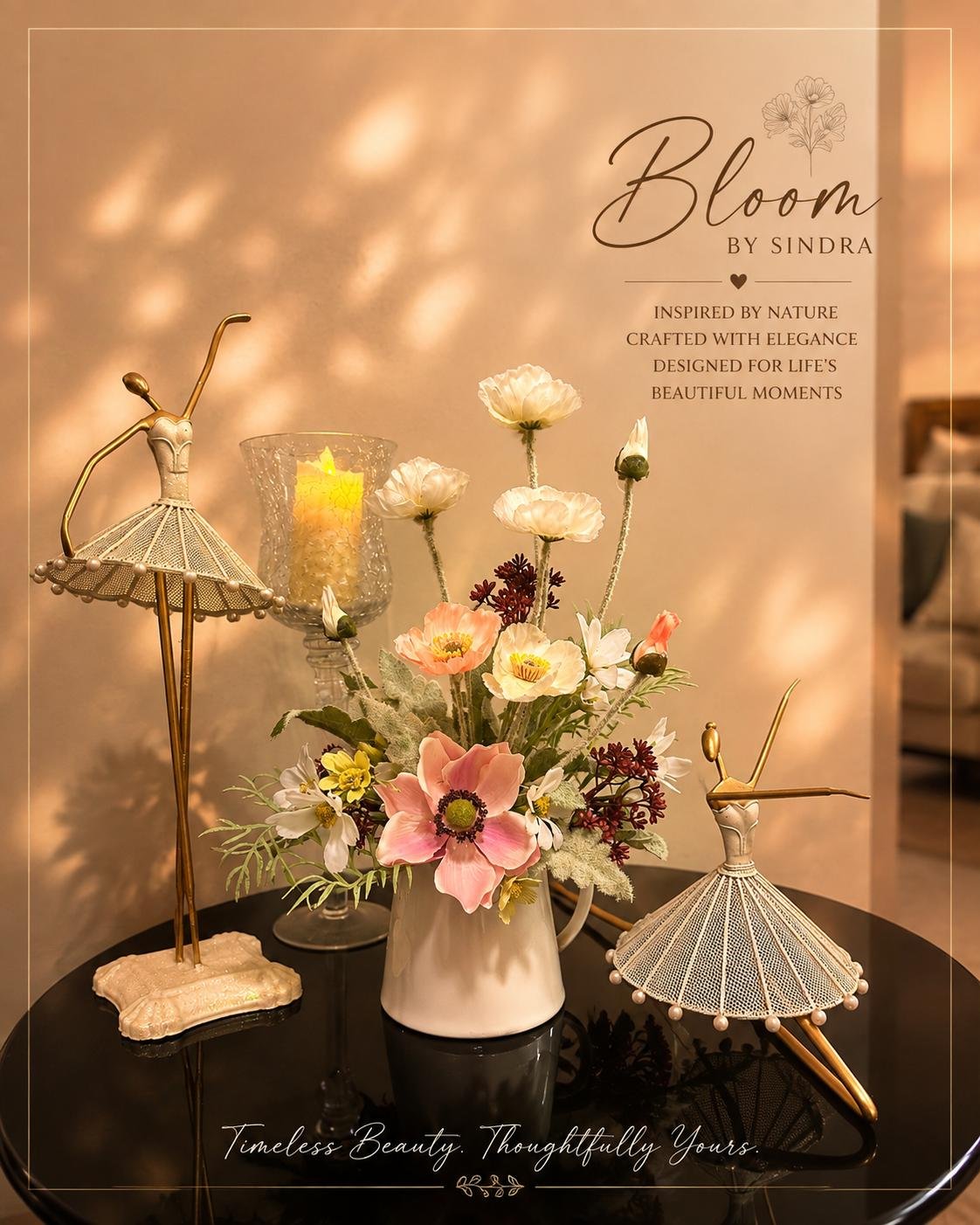 Bloom by Sindra branded photo of a white ceramic pitcher filled with poppies and anemones, styled with ballerina figurines